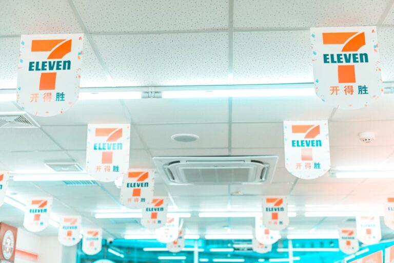 Ceiling view of a retail store with clean, white tiles and 7-Eleven banners, illustrating a spotless environment for effective retail cleaning.